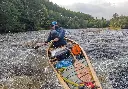 Broadland 15 Composite Filled with Gear in Rough Water Paddled by Ray Goodwin MBE